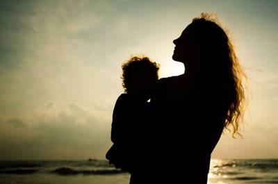 woman holding child depressed