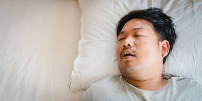 man with sleep apnea snoring