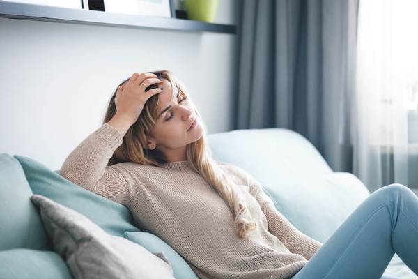 woman on couch not feeling well possibly due to anemia