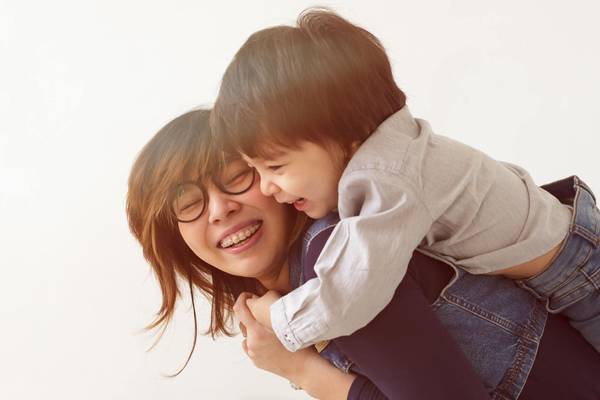 child hugging mom with glasses